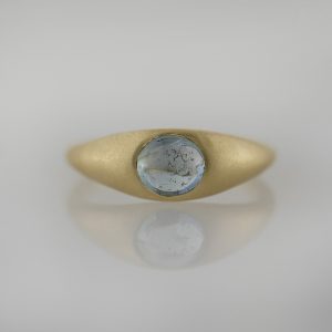 Flush set sapphire cabochon in a signet-style tapered band with a sandblast finish. Exclusively designed and handcrafted in-house, in Portland, Oregon.