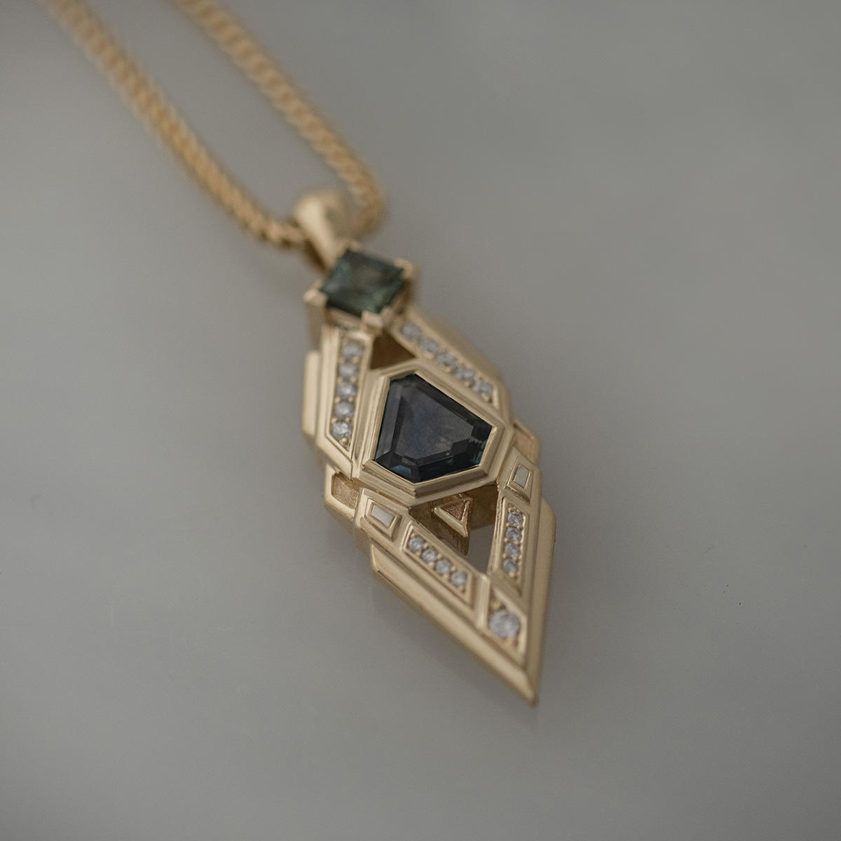 Sapphire and diamond geometric pendant in yellow gold